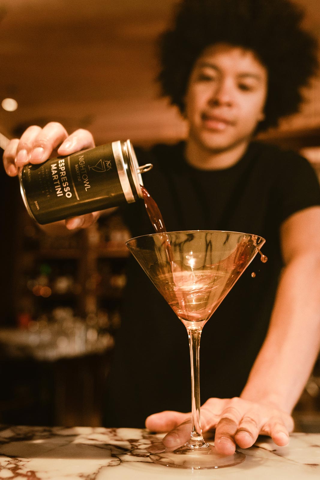 Bartender pouring a NightOwl espresso martini